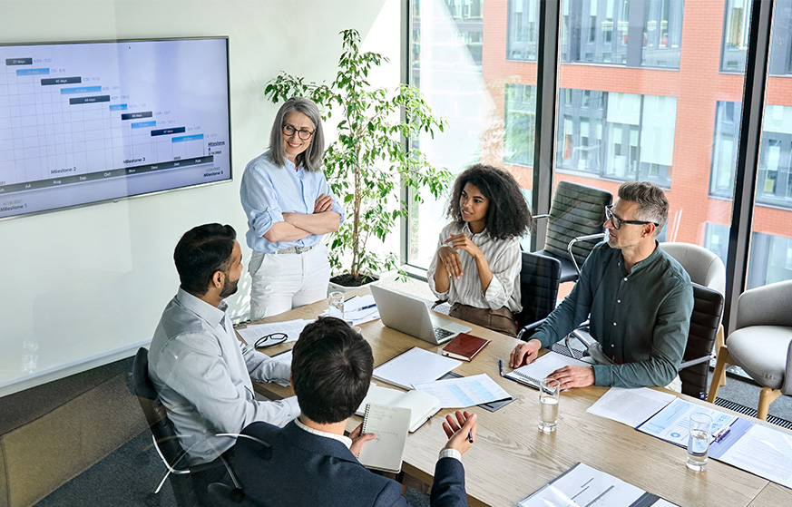 Team reviewing a chart together in a meeting room.