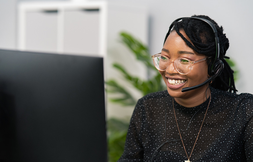 Woman wearing headset talking to customers.