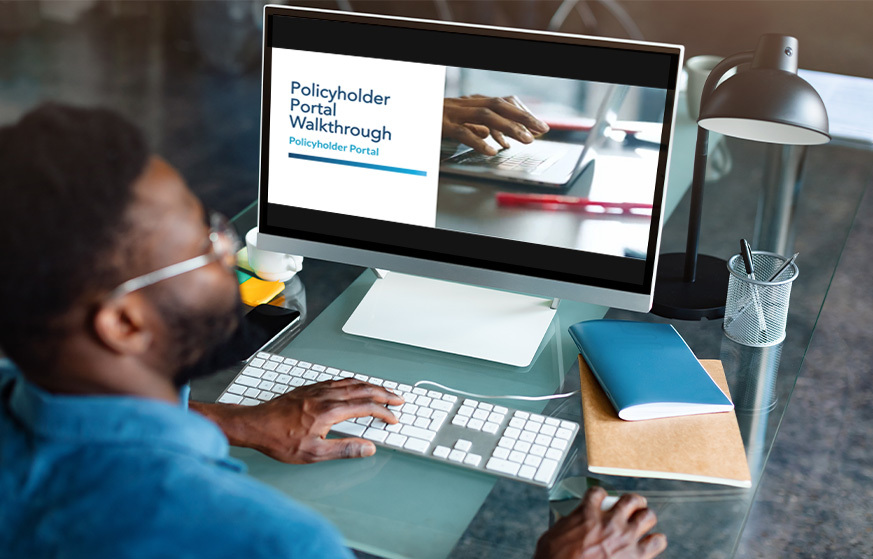 Man on desktop computer watching the policyholder video.